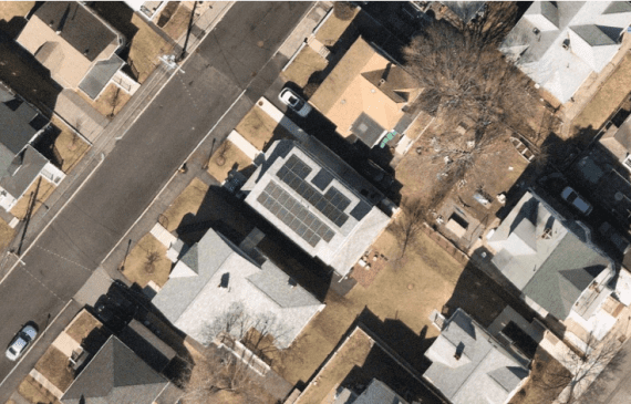 Birds eye view of house with solar panels on roof