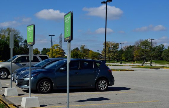 Parking lot with zip car reserved spots and cars parked