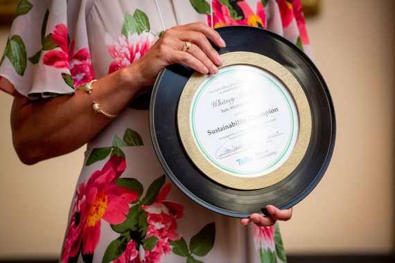 Close-up of person holding a sustainability champion award