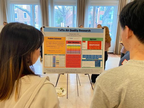 Two students look at research poster