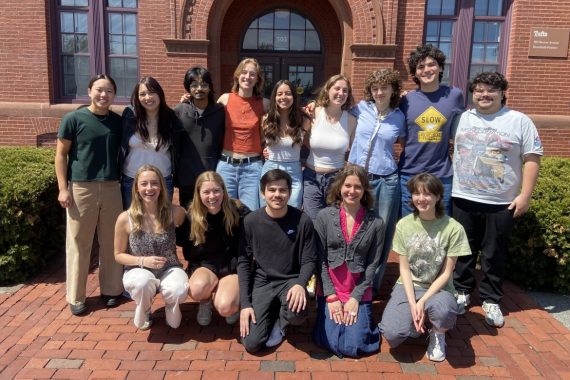 Students in Sustainable CORE Fellows programs pose in front of a building.