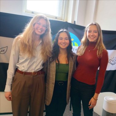 Three students pose for a picture at a food equity conference
