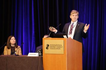 Eric Hines, Professor of the Practice in Civil and Environmental Engineering, stands at a podium presenting on strategies for transformative engineering education.