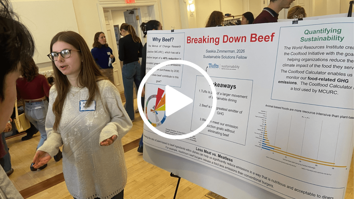 A student presents their research on sustainable beef during poster session