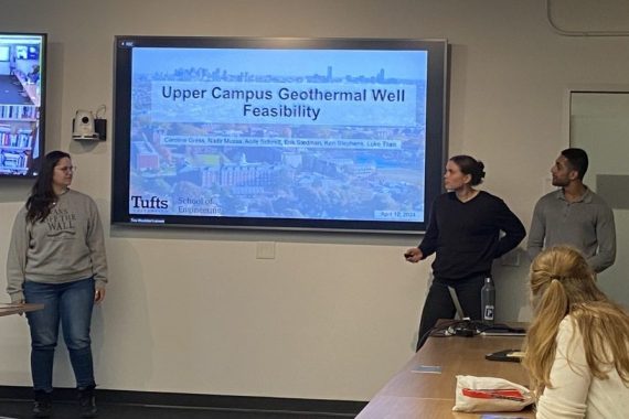 Three students present to a room of faculty and staff about their campus geothermal project